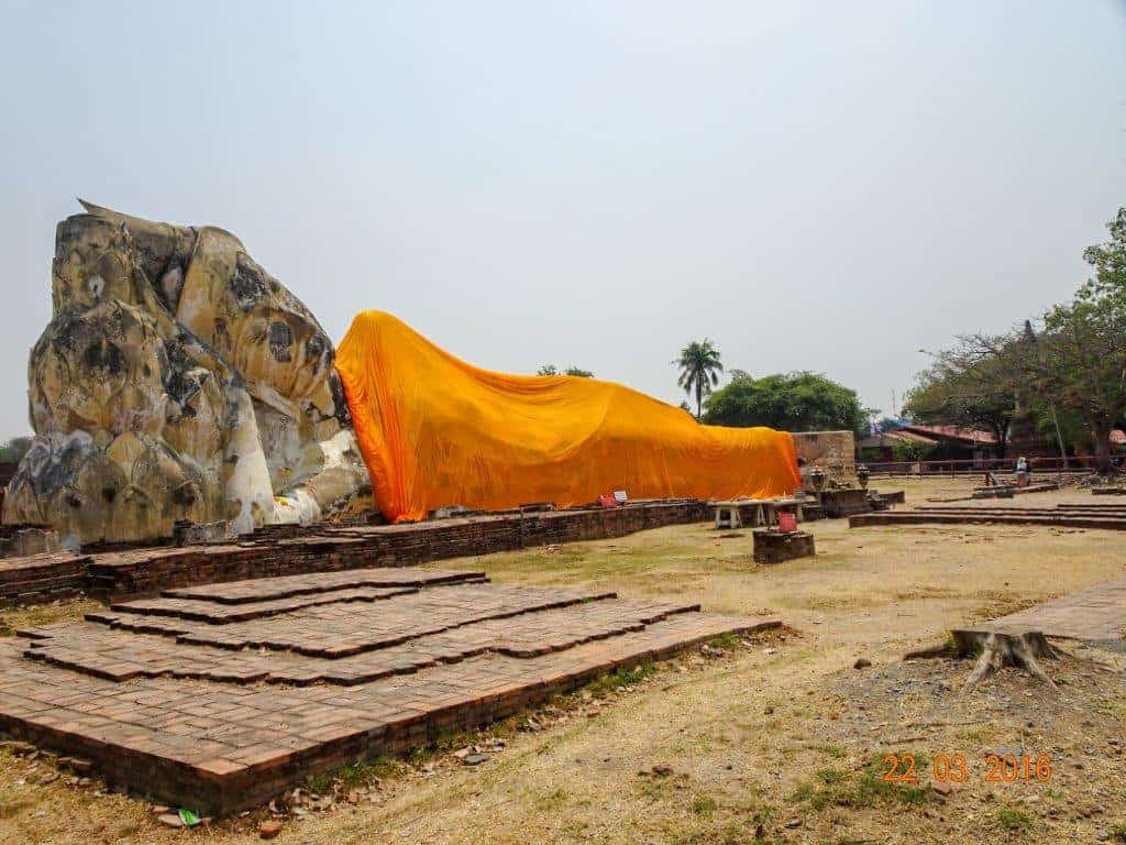 stone buddha lying down with orange cloth