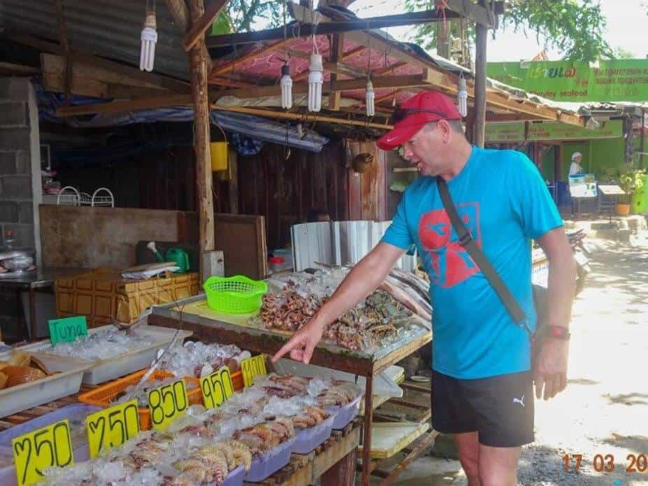 Man in front of a fish stall