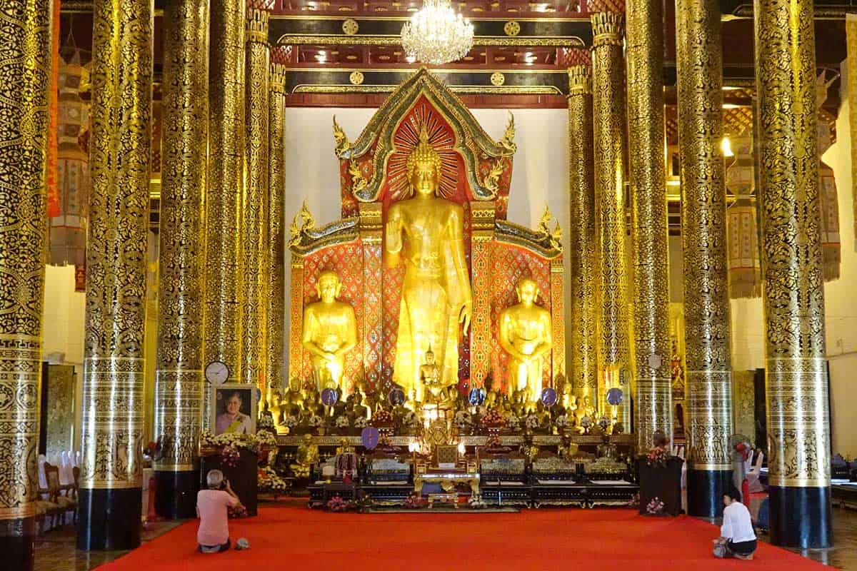 Inside a large Asian temple with gold statues
