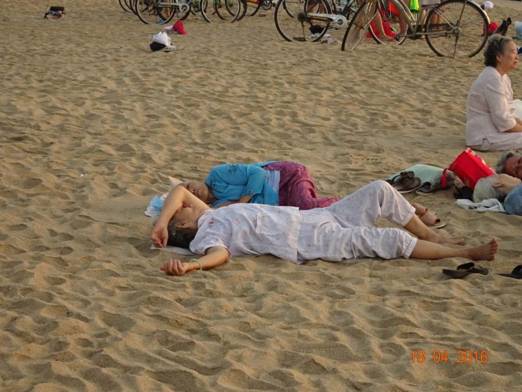 Two older woman asleep on the beach