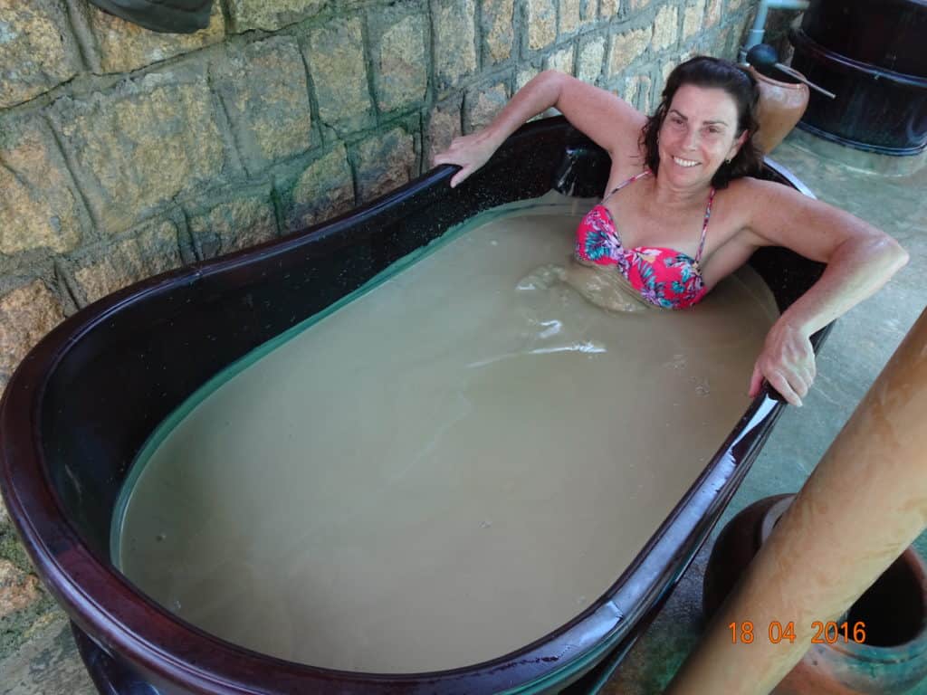 Woman in a tub of mud