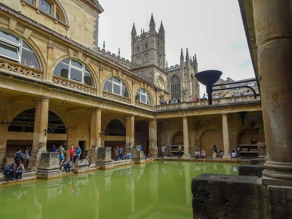 Green water pool surrounded by a building