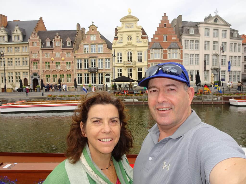 Man and woman in front of a river in a city