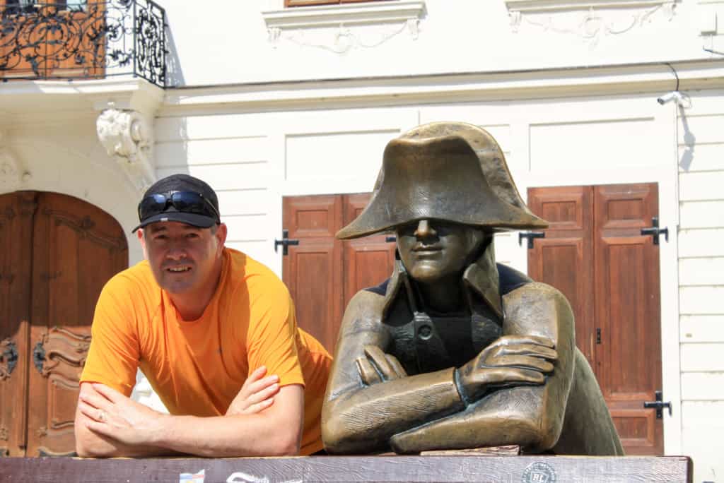 Man next to a bronze statue
