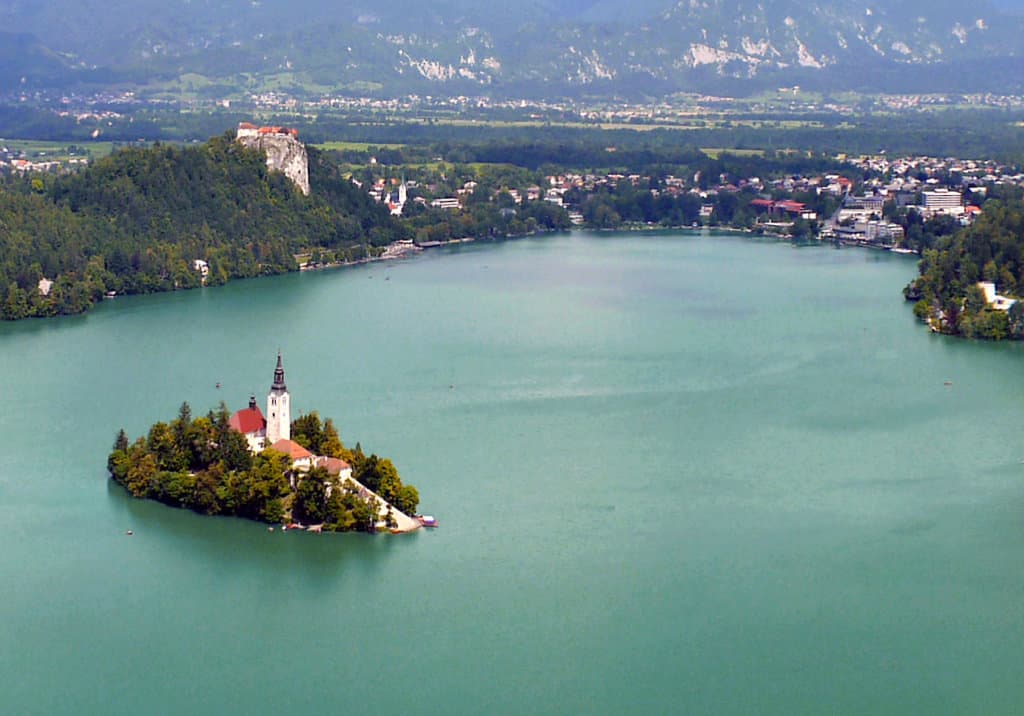 View of a lake with surrounding town and church on an island