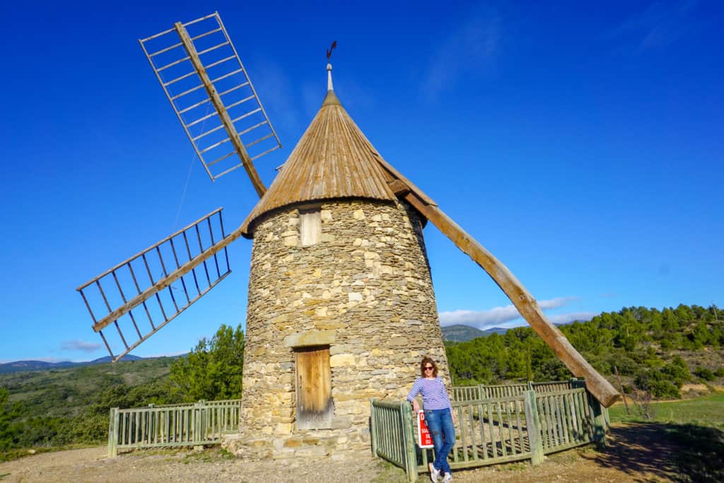 Woman in front of old windmill