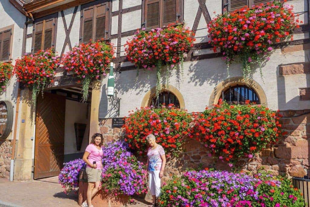 Two ladies in front of flower baskets