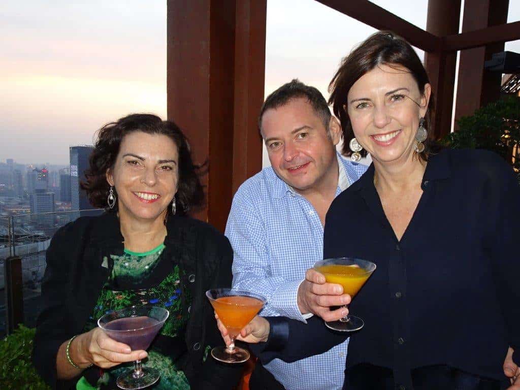 Three people enjoying cocktails
