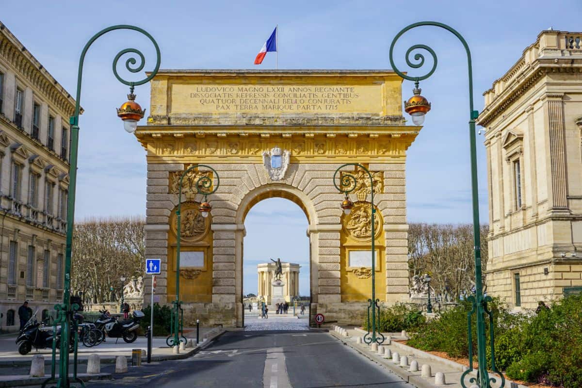 Stone archway with French flag