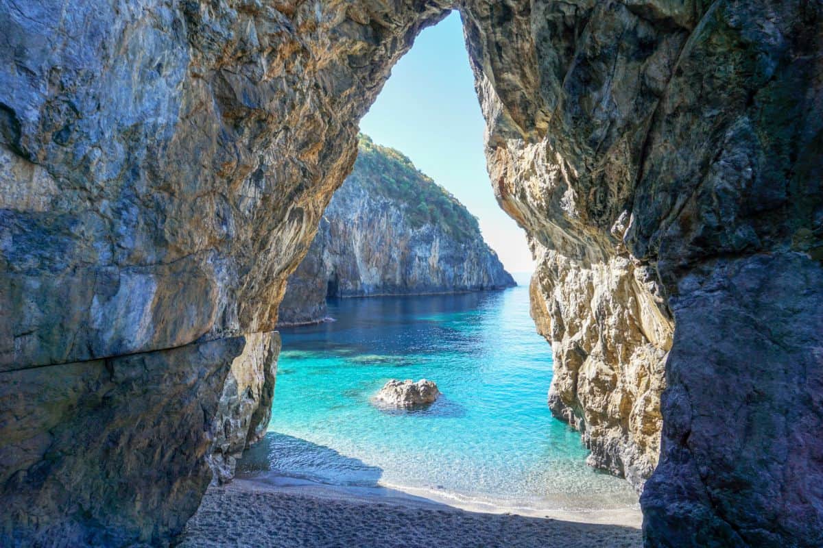 An arch leading to blue waters of San Nicola Arcella