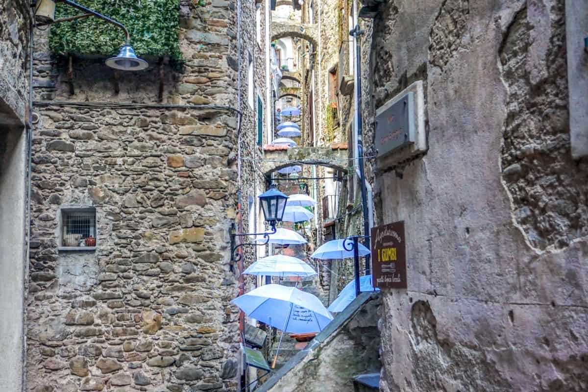 Umbrellas above an ancient lane in Dolceacqua, Italy