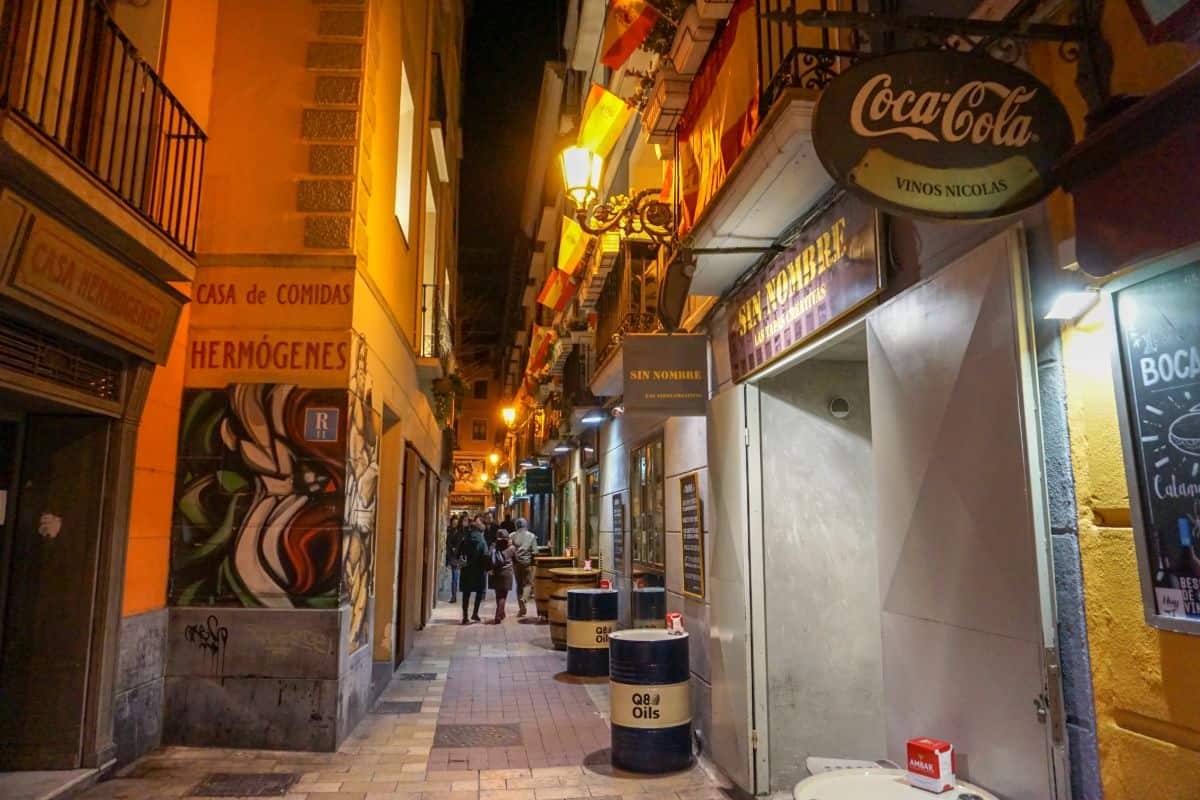 A narrow lane with cafes at night in Zaragoza, Spain