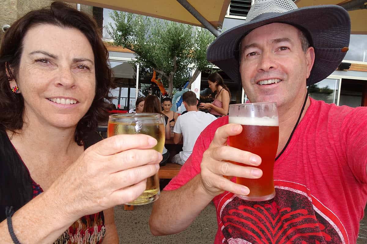 Couple toasting with two beers
