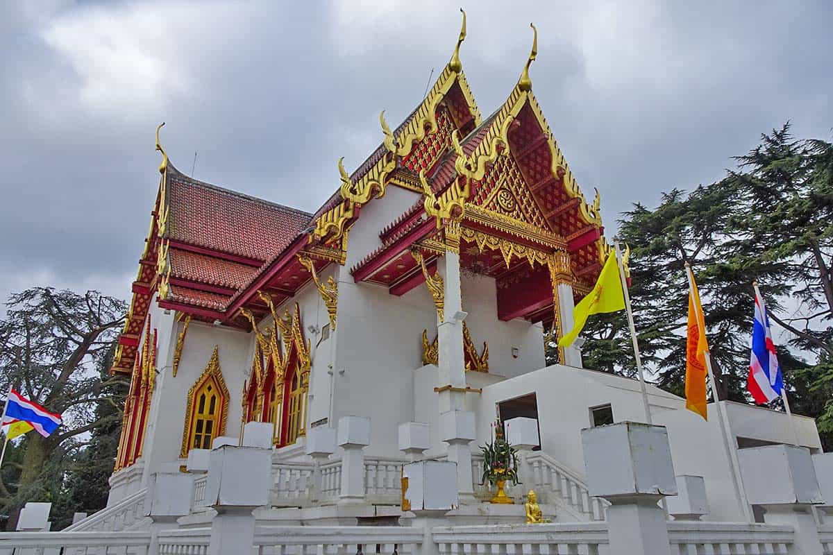 White temple with red roof and gold eaves