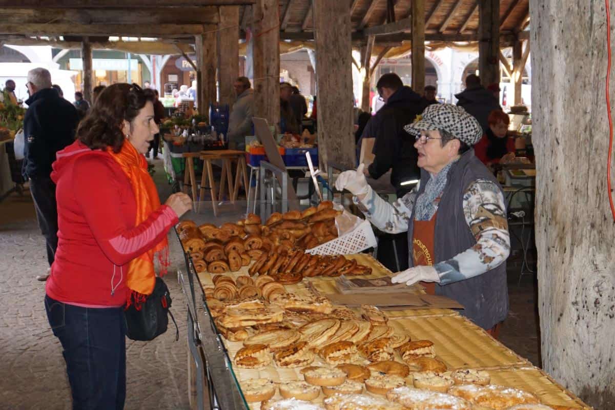 Lady buying bread in a market