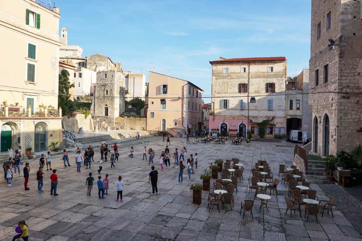 Children playing in a town square