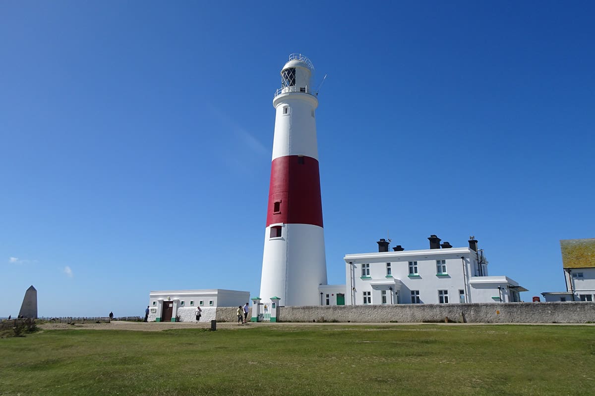 A tall white and red lighthouse