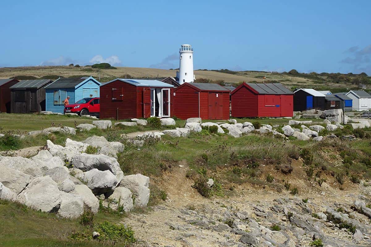 Beach huts and a small lighthouse