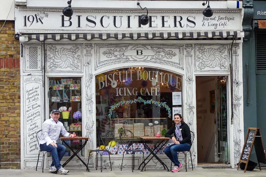 A couple sitting outside a coffee and biscuit shop