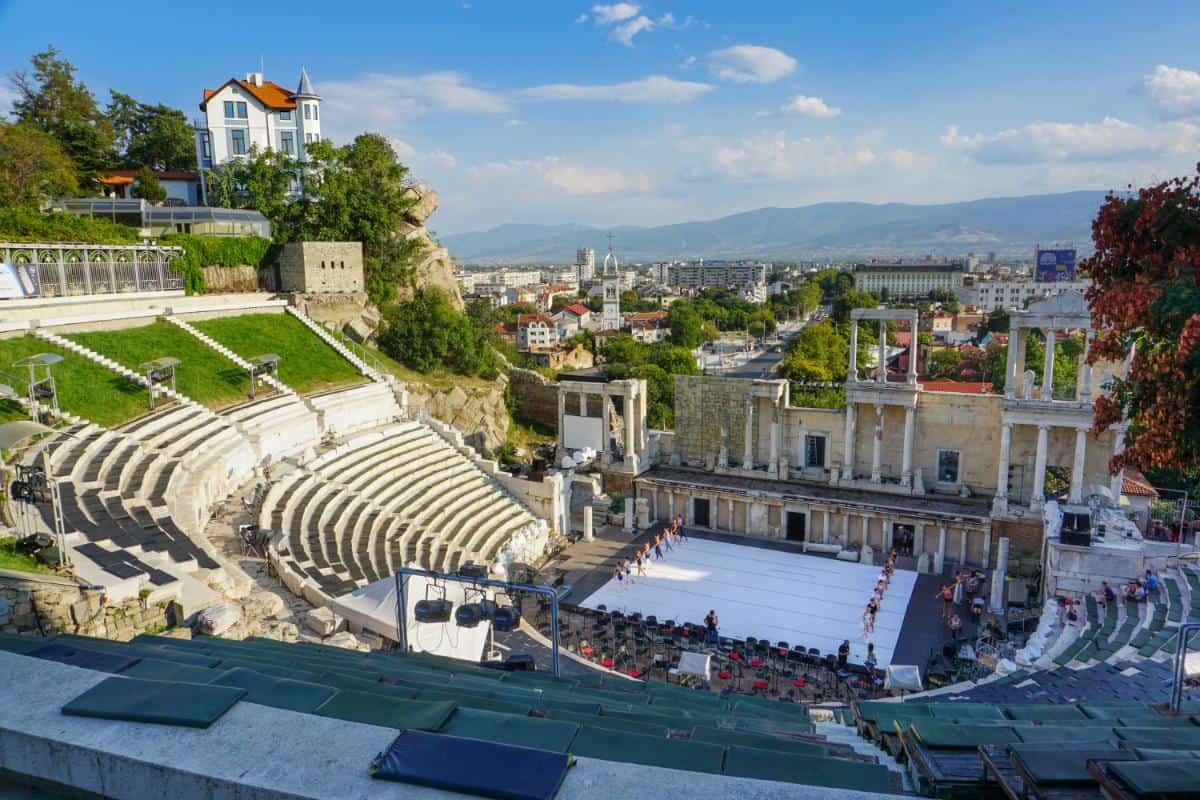 View over an ancient amphitheater with ballet dancers practicing
