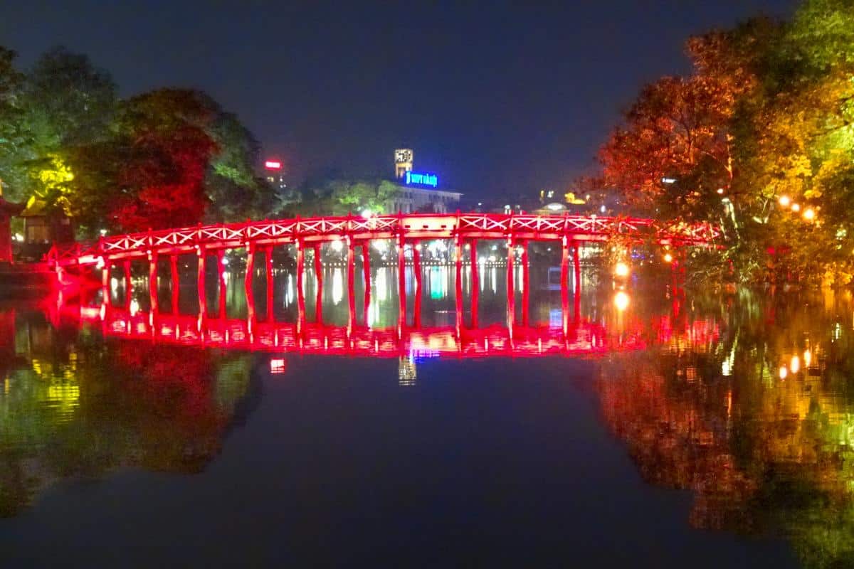 A red bridge over a lake in the evening