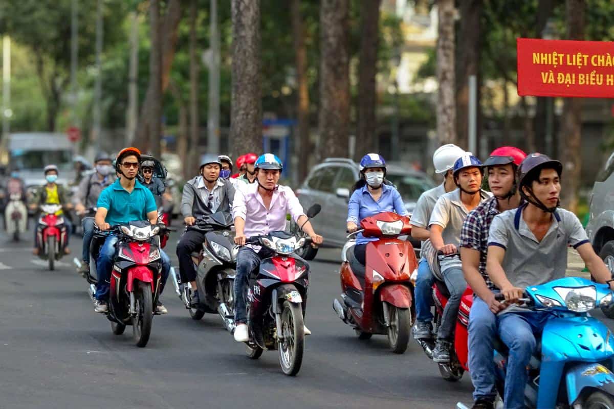 Commuters riding motorbikes in a city