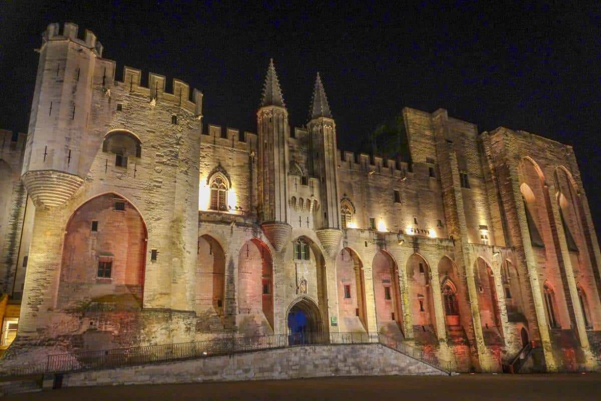 A stone palace lit up at night