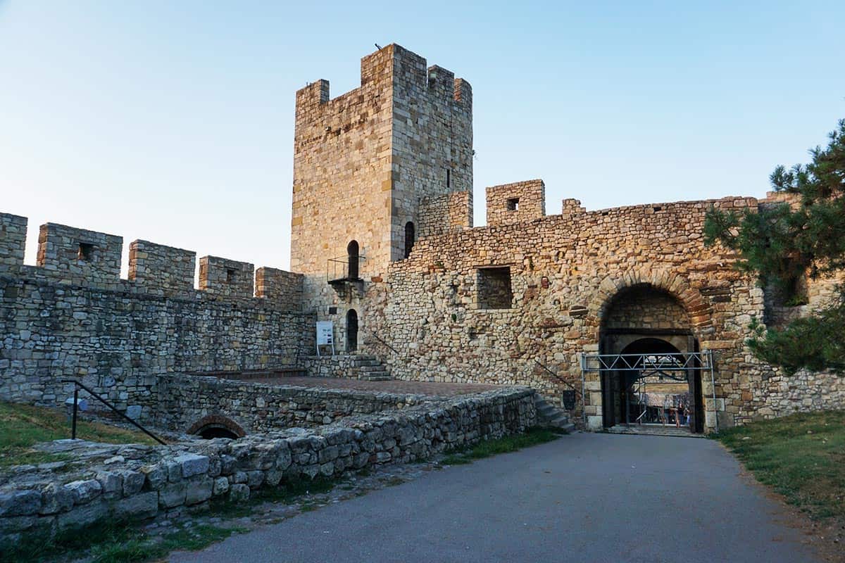 stone fortress with square tower and arch gateway