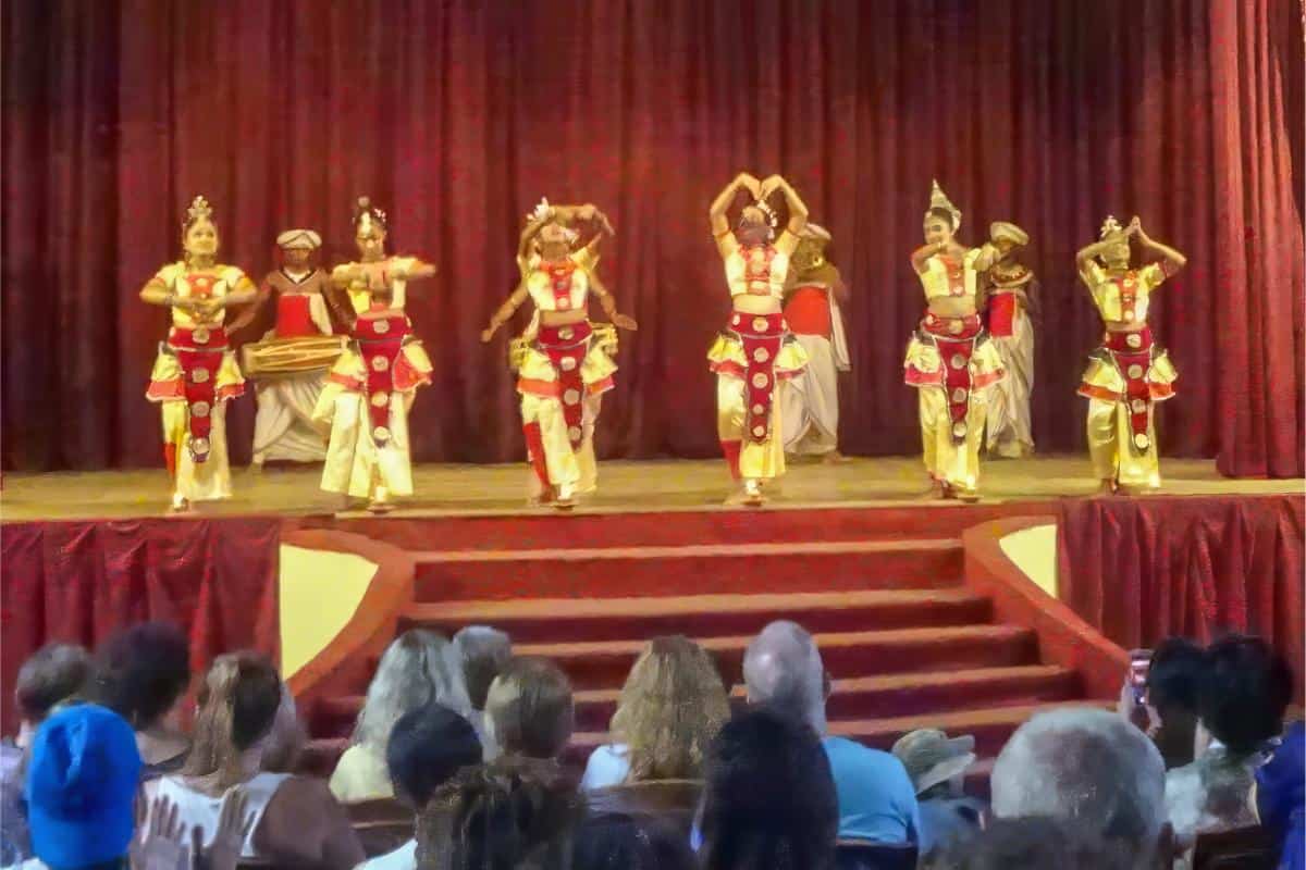Dancers on a stage in red and gold clothing