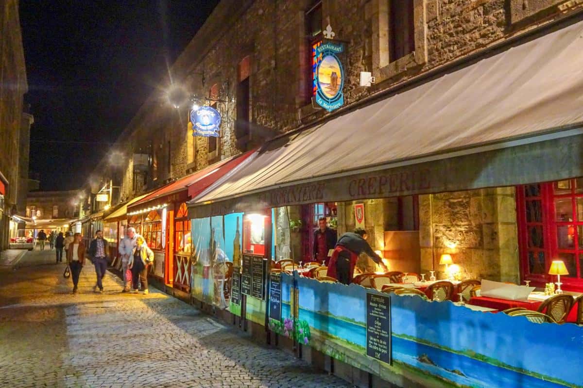 A street lined with restaurants at night